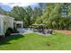 Sprawling backyard with a pool, patio, fire pit, and lush greenery at 126 Owens Mill Pl, Canton, GA 30115