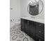 Modern bathroom features a round mirror, black vanity, and stylish patterned tile flooring at 126 Owens Mill Pl, Canton, GA 30115