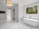 A luxurious bathroom features a soaking tub with natural light at 126 Owens Mill Pl, Canton, GA 30115