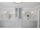 Dual vanity bathroom featuring two round mirrors, modern lighting, white countertops, and ample storage at 126 Owens Mill Pl, Canton, GA 30115