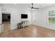 Versatile bonus room with hardwood floors, television, and easy access to other spaces at 126 Owens Mill Pl, Canton, GA 30115