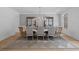Formal dining room featuring hardwood floors, elegant light fixture, paneled walls, and seating for eight at 126 Owens Mill Pl, Canton, GA 30115
