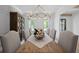 Bright dining room with hardwood floors, light walls, stylish furnishings, and an elegant light fixture at 126 Owens Mill Pl, Canton, GA 30115