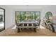 Bright dining room with a rustic wooden table and bench with large windows overlooking the pool at 126 Owens Mill Pl, Canton, GA 30115