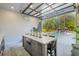 Indoor entertainment area with a wet bar, seating, and glass door with view of the pool at 126 Owens Mill Pl, Canton, GA 30115