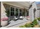 Charming covered porch featuring stone columns and comfortable seating arrangements at 126 Owens Mill Pl, Canton, GA 30115