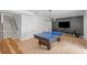 Spacious game room with a ping pong table, modern lighting, and wet bar area at 126 Owens Mill Pl, Canton, GA 30115