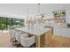 Kitchen island with white countertops, seating, and pendant lighting, overlooking the outdoor dining at 126 Owens Mill Pl, Canton, GA 30115