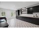 Bright laundry room boasts sleek black cabinetry, white countertops, and decorative patterned flooring at 126 Owens Mill Pl, Canton, GA 30115