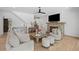 The stylish living room offers comfortable seating, a stone fireplace, hardwood floors and a staircase leading to the second floor at 126 Owens Mill Pl, Canton, GA 30115