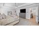 Spacious bedroom with neutral tones, ceiling fan, television, and access to the en suite bath provides a relaxing retreat at 126 Owens Mill Pl, Canton, GA 30115