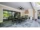 Covered patio featuring an outdoor kitchen, dining table, and large sliding glass doors at 126 Owens Mill Pl, Canton, GA 30115