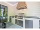 Outdoor kitchen featuring a stainless steel grill, refrigerator, and storage at 126 Owens Mill Pl, Canton, GA 30115