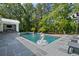 Backyard pool and outdoor bar with lounge chairs and landscaped foliage at 126 Owens Mill Pl, Canton, GA 30115