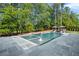 Backyard pool with a gray stone surround and lush greenery with an out door pool-side bar and lounge at 126 Owens Mill Pl, Canton, GA 30115