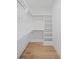 A clean, organized walk-in closet featuring shelving, drawers, and racks at 126 Owens Mill Pl, Canton, GA 30115