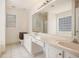 Bright bathroom featuring a long vanity with double sinks and a glass block window at 2770 Nautical Way, Villa Rica, GA 30180