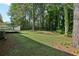 Spacious and shaded backyard, complete with a wooden deck and mature trees at 4954 Browns Mill Rd, Lithonia, GA 30038