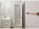 Bathroom featuring a vanity sink, a medicine cabinet, and a view into the next room at 4954 Browns Mill Rd, Lithonia, GA 30038