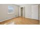 This cozy bedroom has hardwood floors, a window, and a closet for optimal space and storage at 4954 Browns Mill Rd, Lithonia, GA 30038