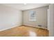 Cozy bedroom featuring hardwood floors, a window for natural light, and ample space at 4954 Browns Mill Rd, Lithonia, GA 30038