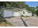 Charming single-story home with an attached two-car garage and a long driveway at 4954 Browns Mill Rd, Lithonia, GA 30038