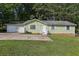 Charming single-story home with an attached two-car garage and a well-maintained front yard at 4954 Browns Mill Rd, Lithonia, GA 30038