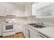 Cozy kitchen featuring white cabinetry, laminated countertops, and stainless steel sink at 4954 Browns Mill Rd, Lithonia, GA 30038