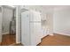 Bright kitchen featuring white cabinets, appliances and adjacent utility area at 4954 Browns Mill Rd, Lithonia, GA 30038