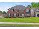 Beautiful two-story brick home with a well-manicured lawn and dark shutters at 6330 Shell Sw Dr, Atlanta, GA 30331