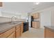 The kitchen is open and features wood cabinets and black appliances at 6330 Shell Sw Dr, Atlanta, GA 30331