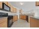 Kitchen featuring wood cabinets and black appliances at 6330 Shell Sw Dr, Atlanta, GA 30331