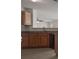 Well-lit kitchen with wood cabinets and stainless steel dishwasher at 6330 Shell Sw Dr, Atlanta, GA 30331