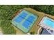 Aerial view of community tennis courts next to an outdoor pool surrounded by trees at 6330 Shell Sw Dr, Atlanta, GA 30331