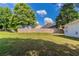 Large green lawn with trees and a wooden privacy fence in a home's backyard at 7161 Boulder Pass, Union City, GA 30291