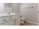 This bathroom features a white vanity and toilet, a mirrored wall, and tile flooring at 7161 Boulder Pass, Union City, GA 30291