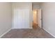 This bedroom features neutral walls, soft carpet, and double doors to a closet for plenty of storage at 7161 Boulder Pass, Union City, GA 30291