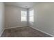 Bright bedroom with neutral paint and filled with light from the two windows at 7161 Boulder Pass, Union City, GA 30291