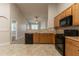 Kitchen with tile floors, wood cabinets, and open view into the living room at 7161 Boulder Pass, Union City, GA 30291