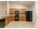 Bright kitchen features wood cabinets, black appliances, and plenty of counter space at 7161 Boulder Pass, Union City, GA 30291