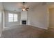 Cozy living room with a fireplace, neutral paint, new carpet, and ceiling fan at 7161 Boulder Pass, Union City, GA 30291