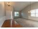 Bright living room featuring vaulted ceilings, new carpet, and large windows, offering ample natural light at 7161 Boulder Pass, Union City, GA 30291