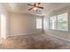 Spacious main bedroom with tray ceiling, ceiling fan, and ample natural light from large windows at 7161 Boulder Pass, Union City, GA 30291