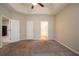 Large primary bedroom showcasing double doors, tray ceilings and access to primary bath at 7161 Boulder Pass, Union City, GA 30291