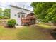 Exterior view of the home featuring a large backyard, deck, and patio space at 1255 Hidden Creek Pt, Cumming, GA 30040