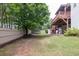 Spacious fenced backyard with mature trees and a multi-level deck, perfect for outdoor activities at 1255 Hidden Creek Pt, Cumming, GA 30040