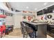 Basement bar with dark cabinetry, countertop seating, and decorative sports memorabilia for entertaining guests at 1255 Hidden Creek Pt, Cumming, GA 30040