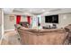 Finished basement featuring a large screen TV, movie posters, and comfortable seating for a theater-like experience at 1255 Hidden Creek Pt, Cumming, GA 30040