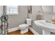 Small bathroom with toilet, sink, and storage basket at 1255 Hidden Creek Pt, Cumming, GA 30040