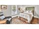 Cozy bedroom with neutral colors, natural light, and hardwood flooring at 1255 Hidden Creek Pt, Cumming, GA 30040